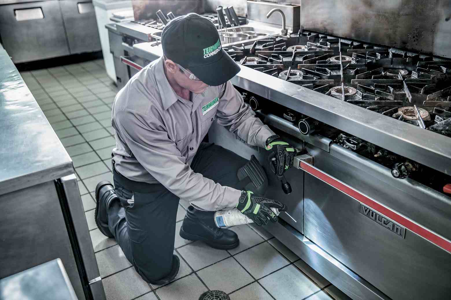 terminix technician in restaurant kitchen